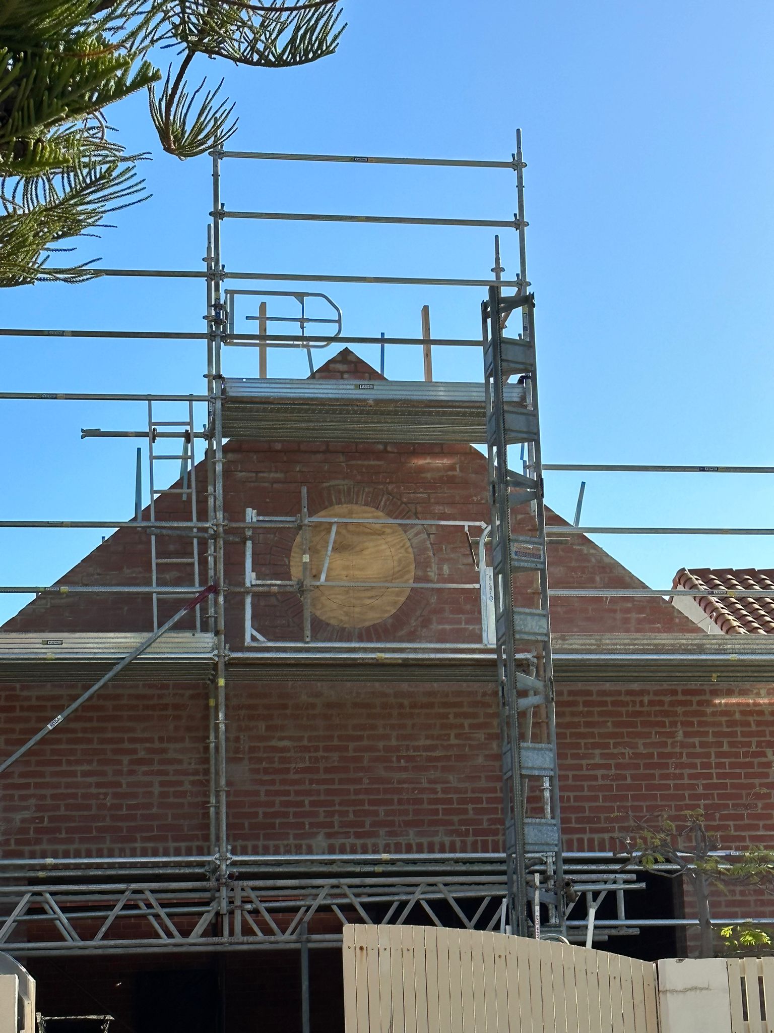 Stage 3 of custom circular window design — detailed brickwork formed around the opening