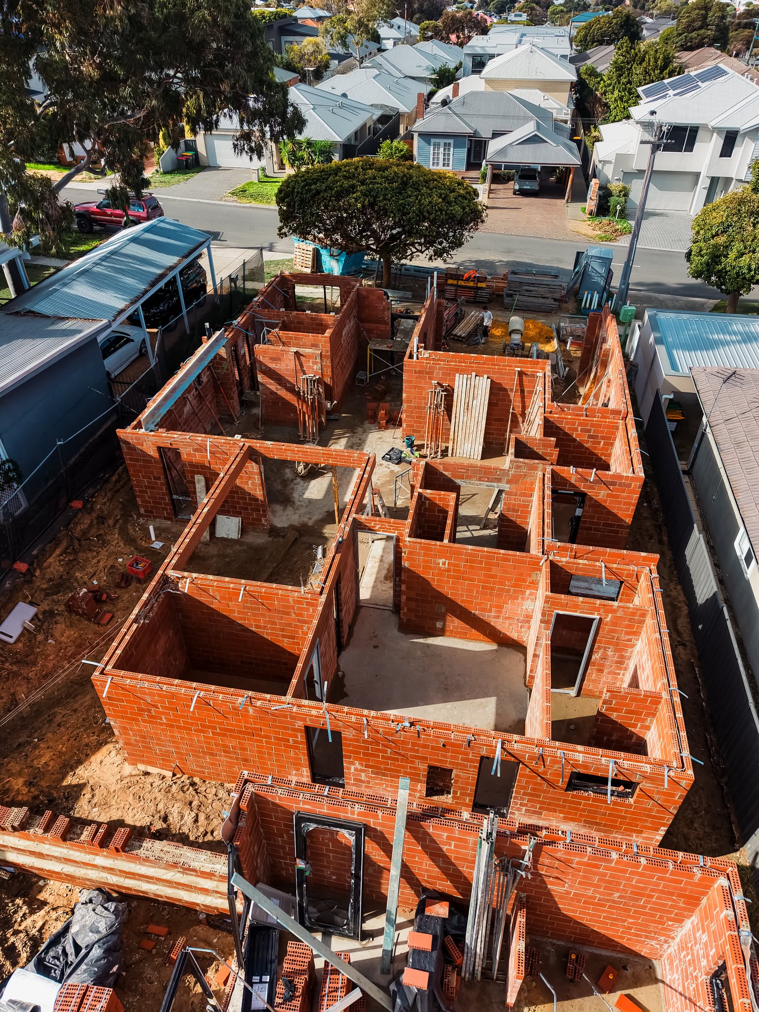 Aerial view of brick walls going up on a new build in a Perth suburb