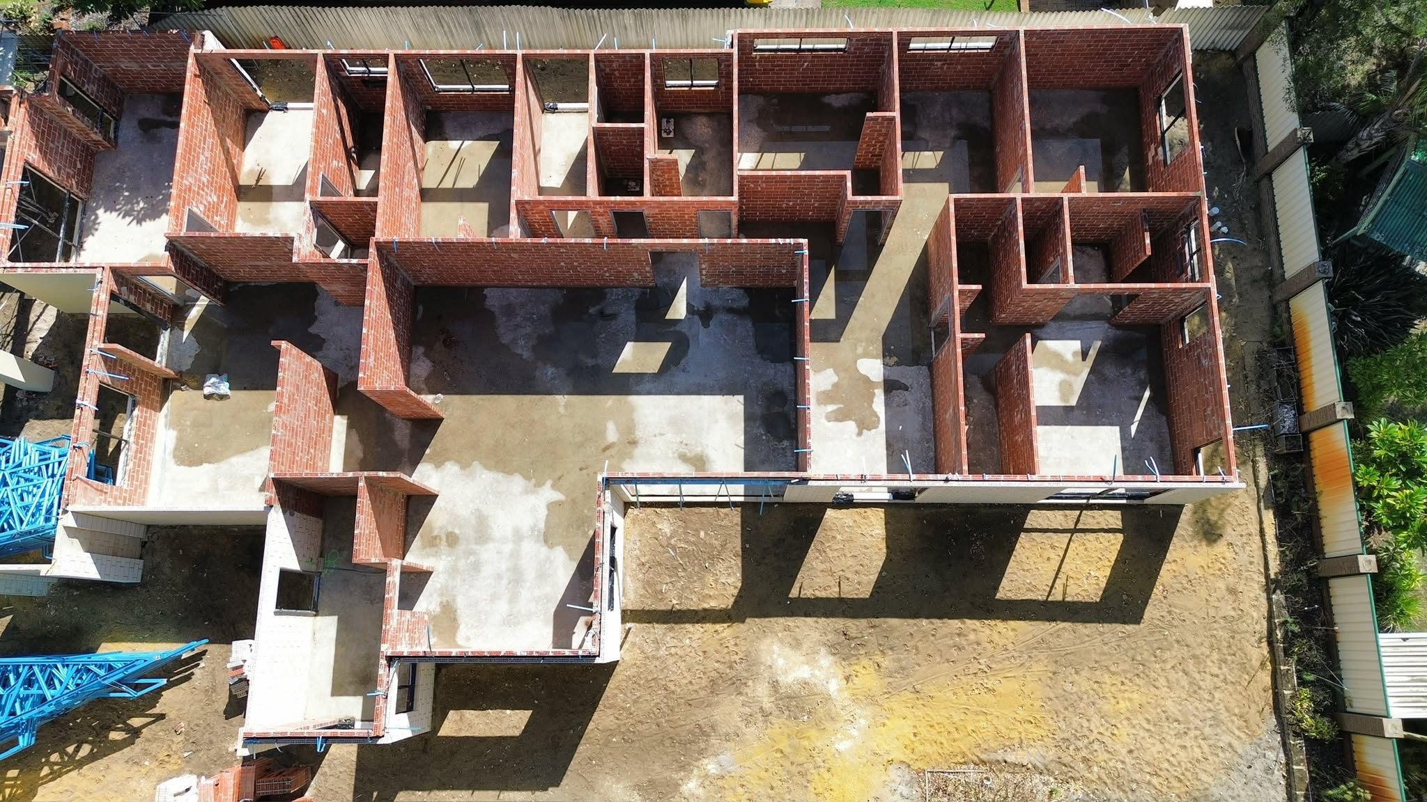 Aerial view of brick walls and slab on a build under construction