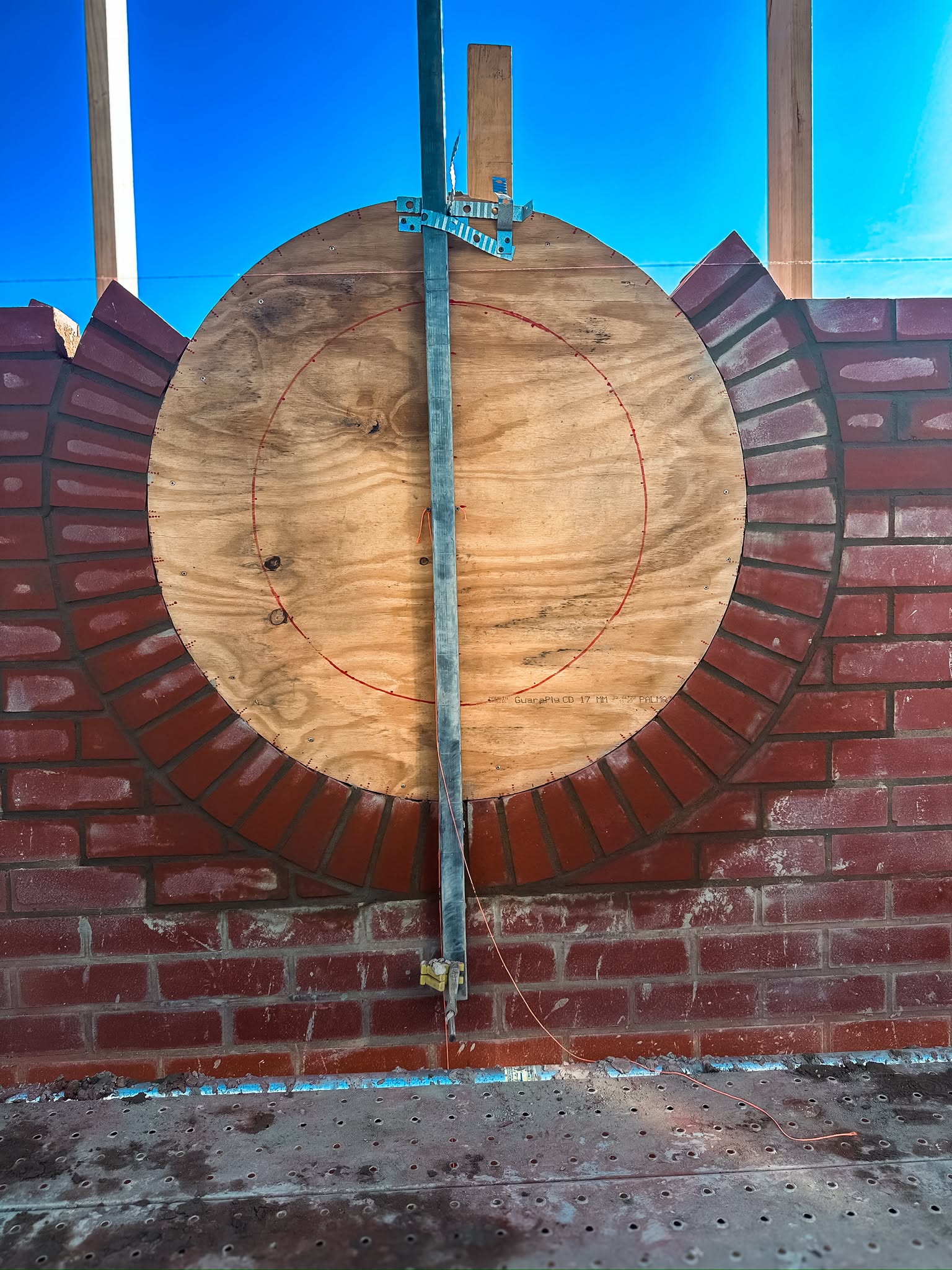 Circular window opening formed in brickwork around a plywood former