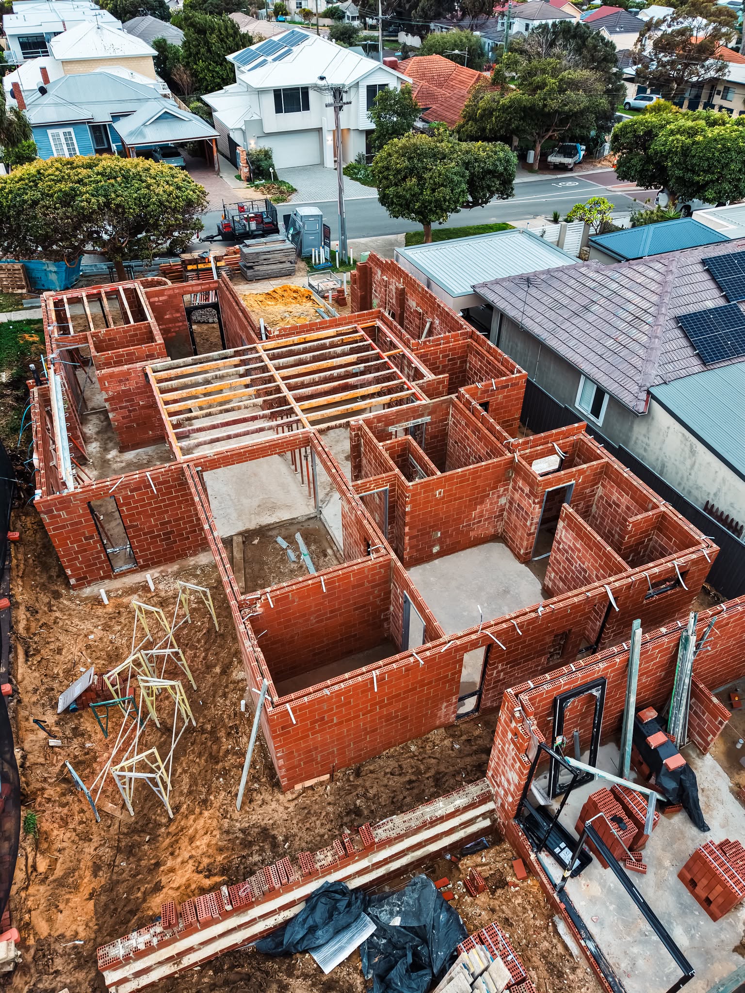 Aerial view of brickwork and timber floor framing on a two storey build