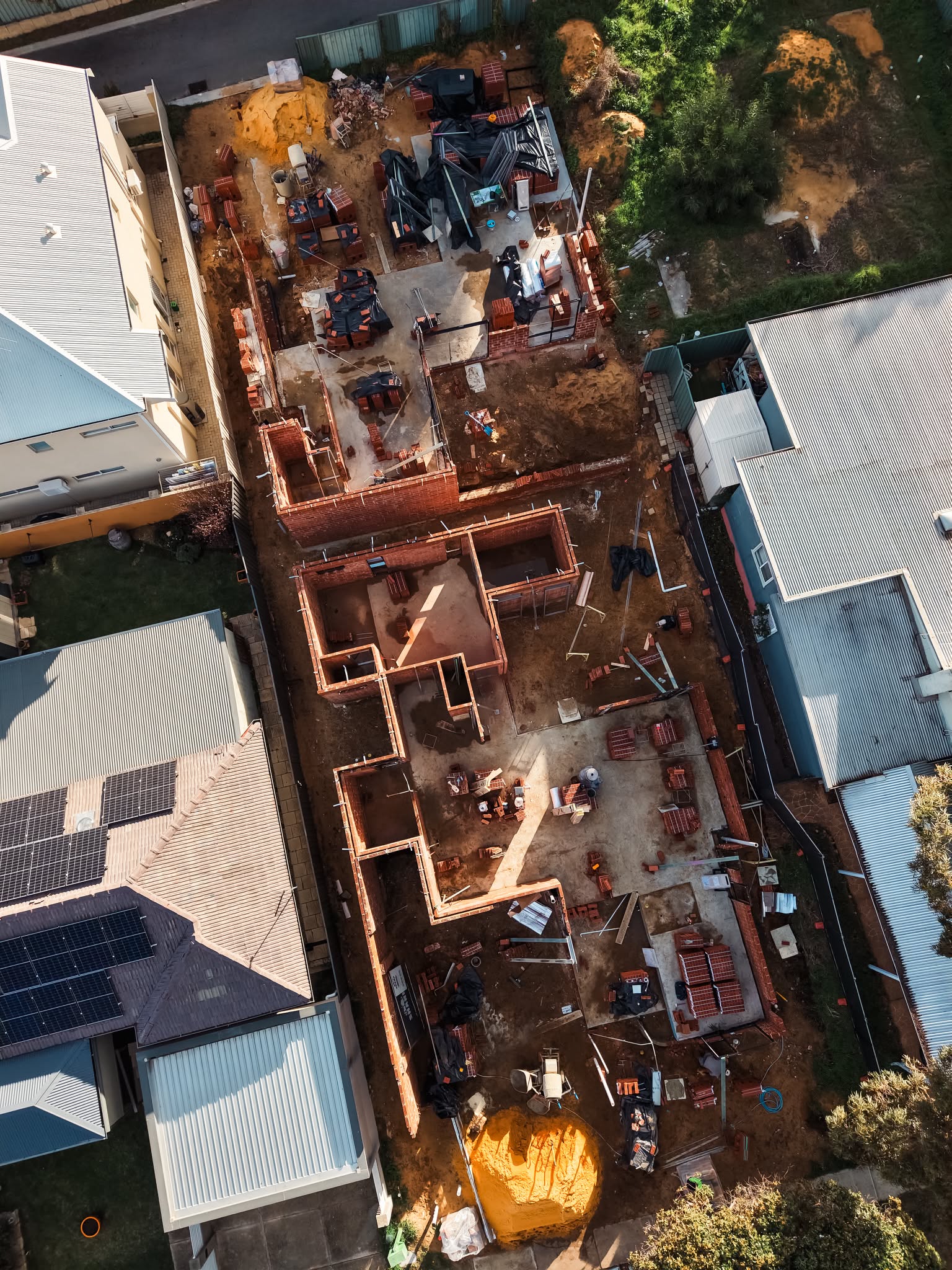 Aerial view of brickwork on a narrow site between neighbouring homes
