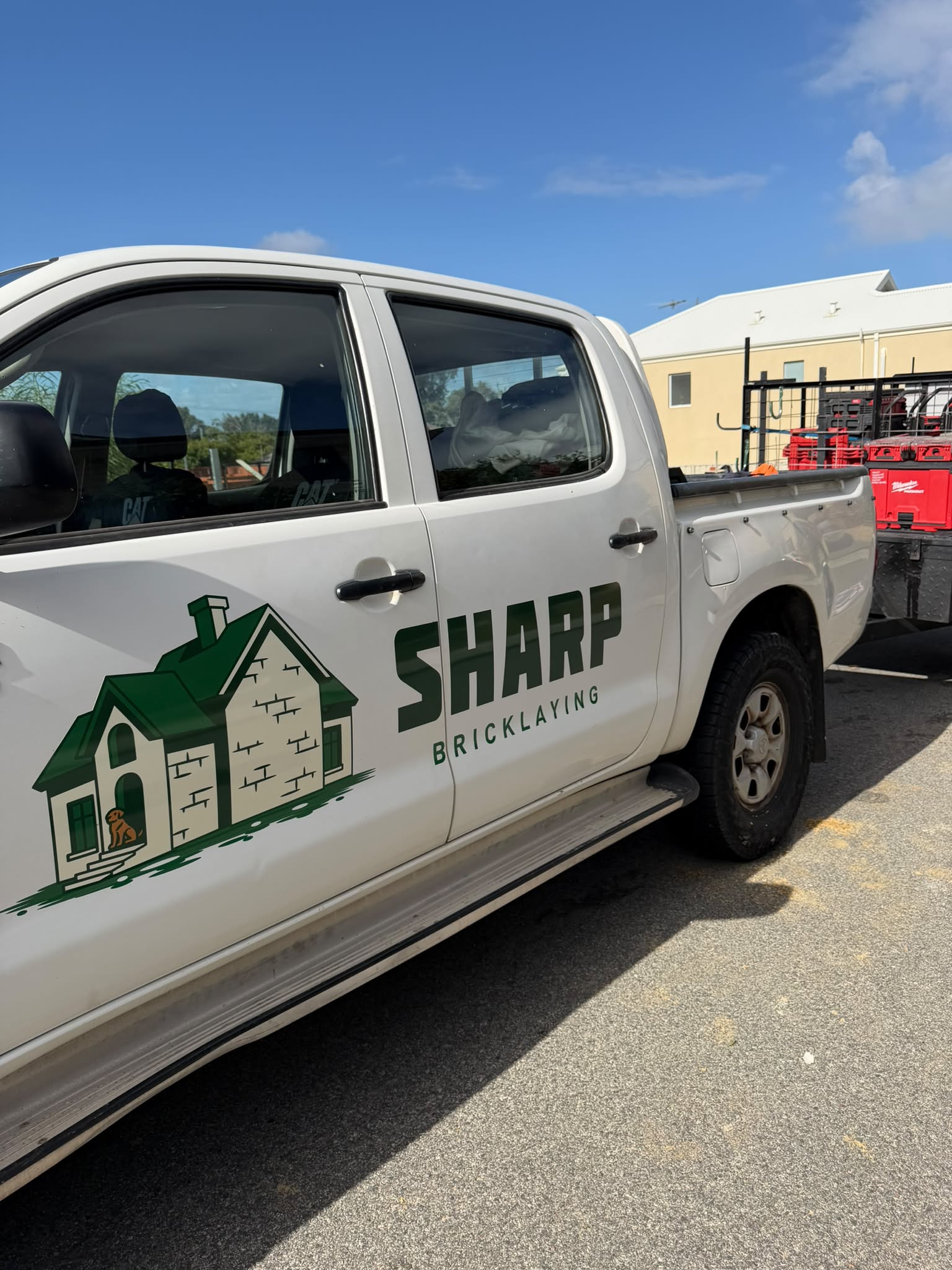 Sharp Bricklaying branded ute parked at a job