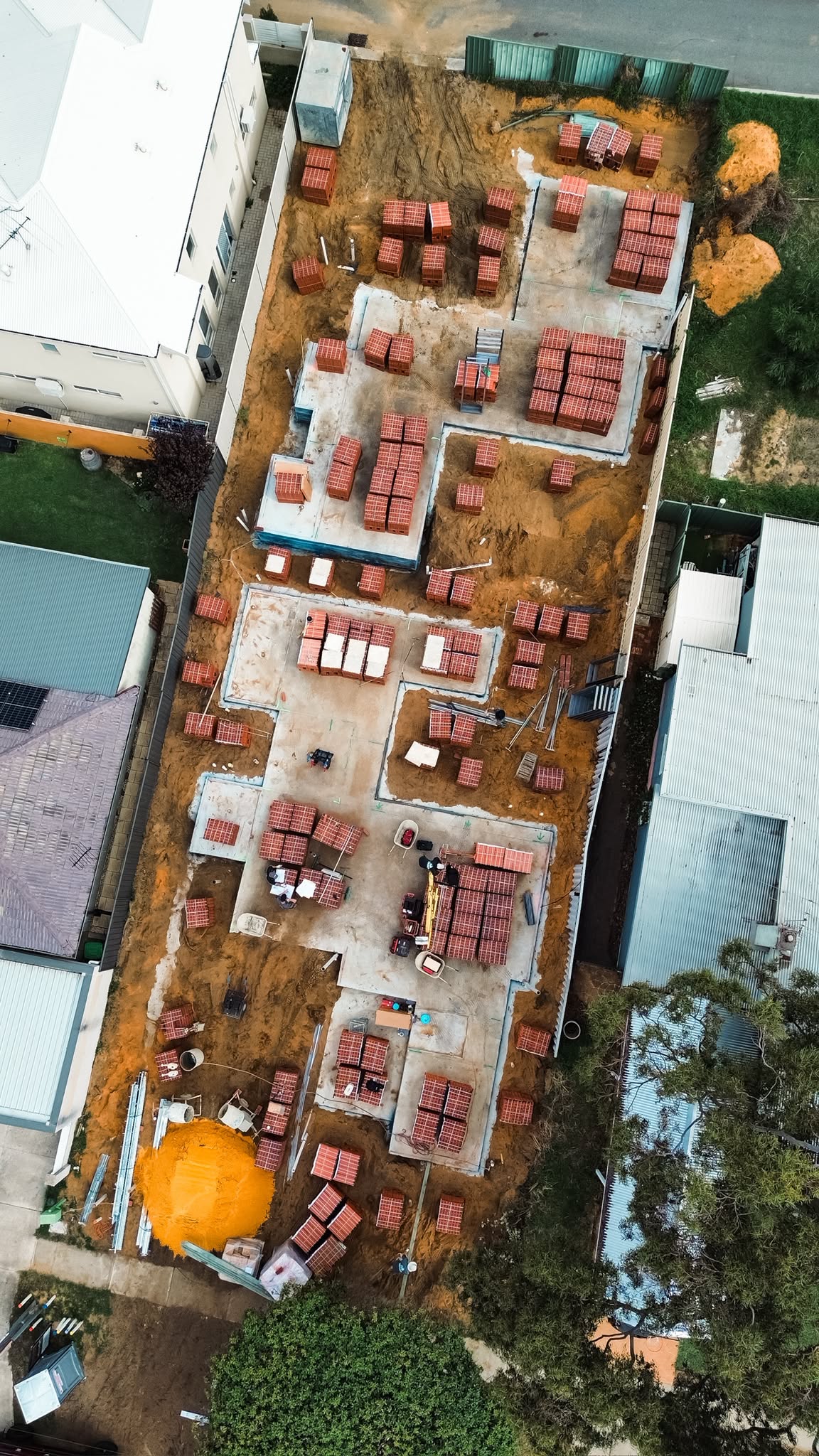 Aerial view of a narrow site with brick packs and materials set out