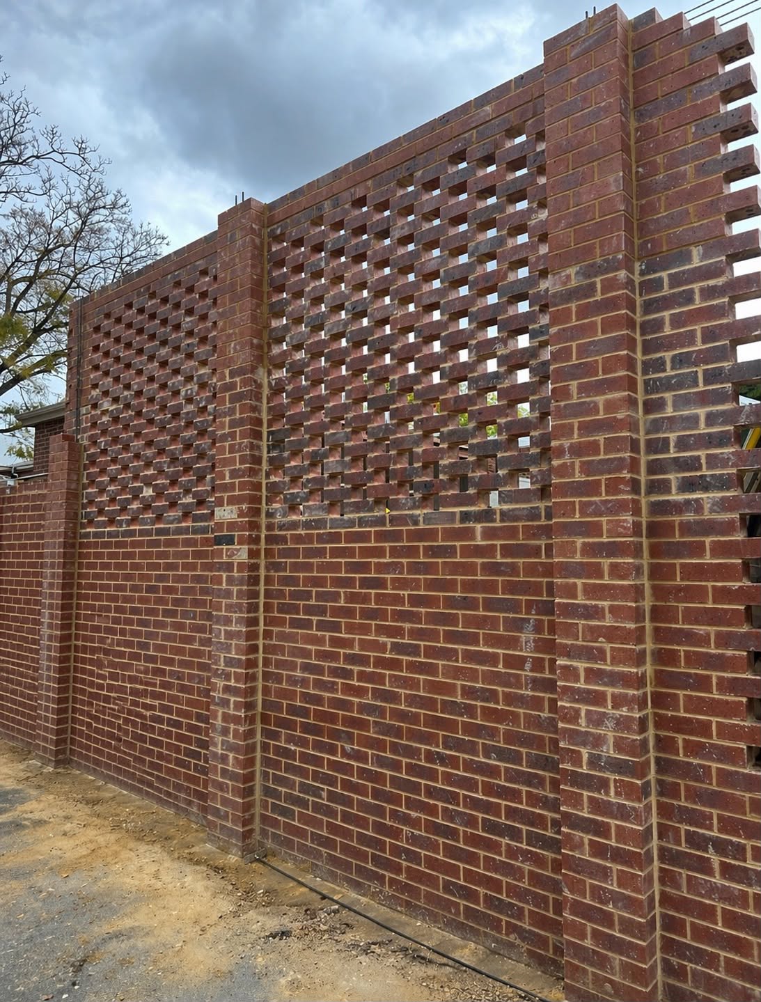 Hit and miss brick screen wall laid in a repeating open bond